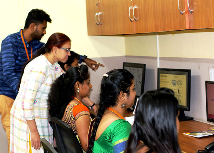 Teachers working on digital learning content in the in-house Department of Excellence at Galaxy Public School to enhance educational outcomes.